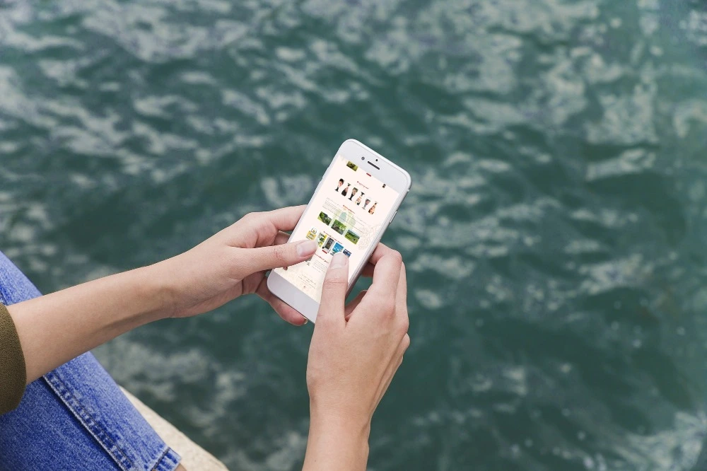 Person-using-smartphone-mockup-on-sea-background